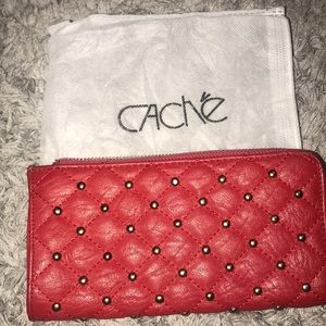 Red leather wallet with gold details.